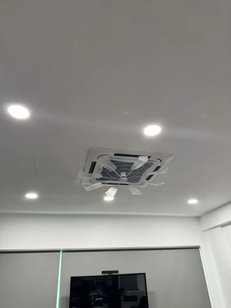 A cassette air conditioning unit set into a finished ceiling