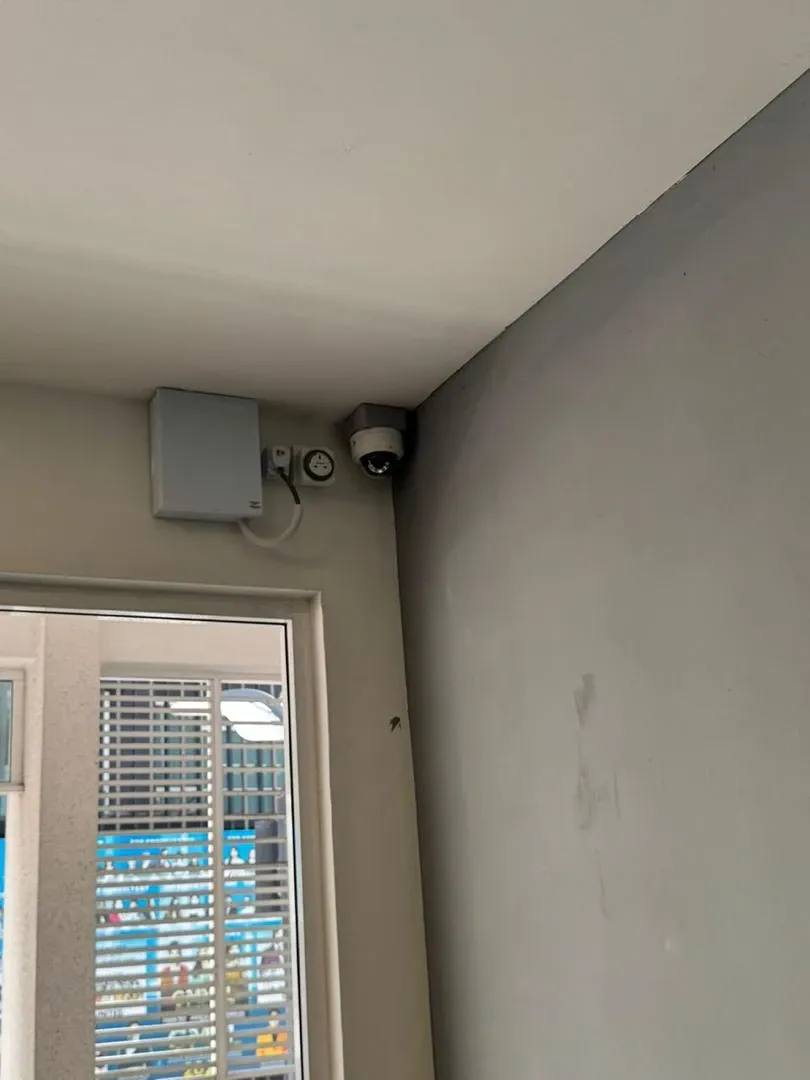 A CCTV camera mounted at a ceiling corner