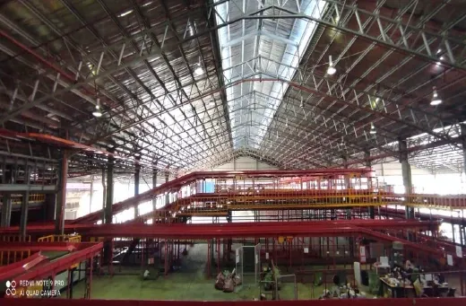 A warehouse interior with high-bay lighting and racking installed
