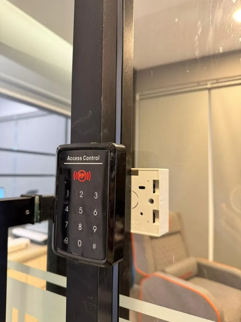 A keypad access control unit fitted beside a door